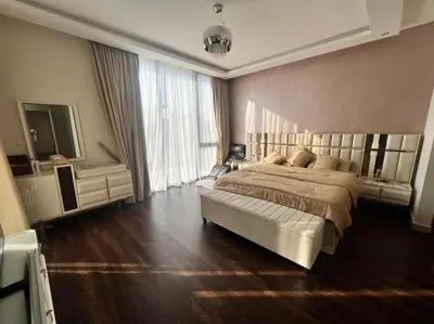 a bedroom with a large bed and a large window at Private room in a luxury villa at Dubai hills in Dubai