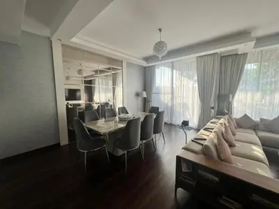 a living room with a couch and a table and chairs at Private room in a luxury villa at Dubai hills in Dubai