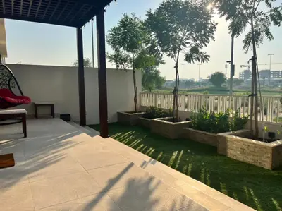 a patio with a fence and some plants at Private room in a luxury villa at Dubai hills in Dubai