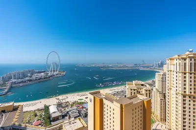 a view of the beach and the ocean from a building at Luxury 2-Bedroom with Sea & Ain Dubai View in Dubai