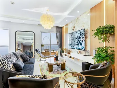a living room with a couch and a table at Luxury 2-Bedroom with Sea & Ain Dubai View in Dubai