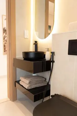 a bathroom with a sink and a mirror at Apartment Studio Blue Wave in Dubai