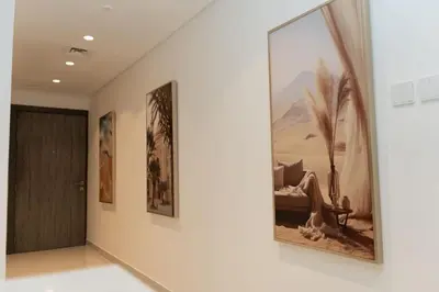 a hallway with a large painting on the wall at Apartment Studio Blue Wave in Dubai