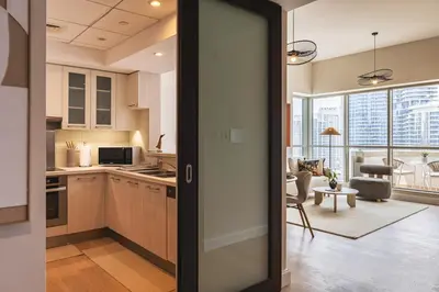 an open door to a kitchen and a living room at The Boulevard Central Suite Near Burj Khalifa in Dubai