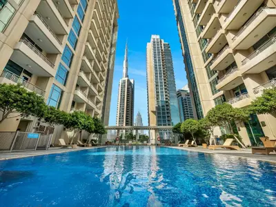 a swimming pool in the middle of a city with tall buildings at The Boulevard Central Suite Near Burj Khalifa in Dubai