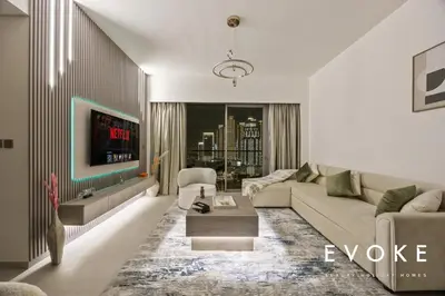 a living room with a couch and a table at Grande 2BR Balcony Burj & Fountain Views by Evoke in Dubai