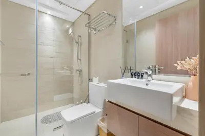 a bathroom with a sink and a toilet and a shower at 1 Bedroom Royal Dubai Stay in Dubai