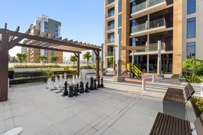 a large chessboard in a courtyard with a building at 1 Bedroom Royal Dubai Stay in Dubai