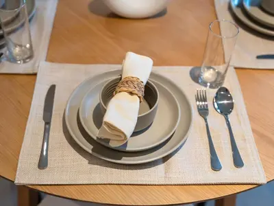 a plate with a napkin on top of a table at Dubai Hills Retreat Garden, Pool & Park Access in Dubai