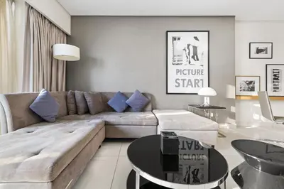 a living room with a couch and a table at BLVD - Damac Paramount with Burj Khalifa View in Dubai