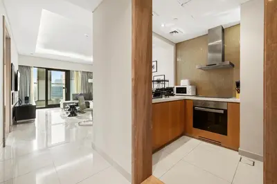 a kitchen with a stove and a microwave at BLVD - Damac Paramount with Burj Khalifa View in Dubai