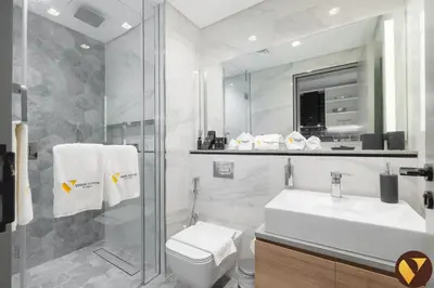 a bathroom with a toilet and a sink and a shower at Vogue Downtown Mag 318 near Burj Khalifa and Dubai Mall, Studio Apartment with Balcony, Canal and City Skyline View, Access to all Amenities in Dubai