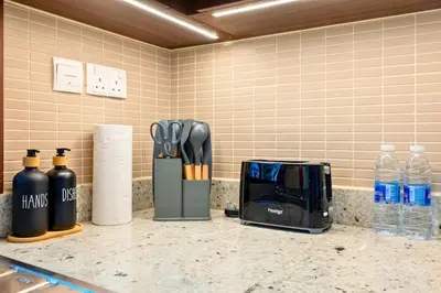 a kitchen counter with a coffee maker and utensils at Iconic Address 1BR Above Dubai Mall by Maxx value homes in Dubai