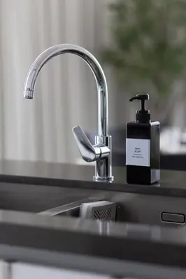 a soap dispenser sitting next to a kitchen sink at Designer 3BR Lagoon Views Gym District One in Dubai