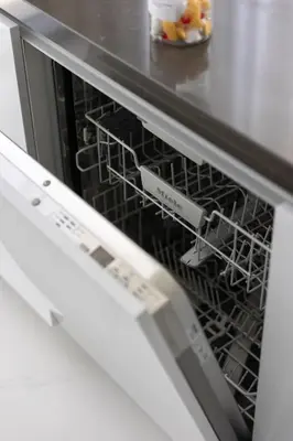 a dishwasher with a rack inside of it at Designer 3BR Lagoon Views Gym District One in Dubai