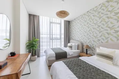 a bedroom with two beds and a large window at Designer 3BR Lagoon Views Gym District One in Dubai