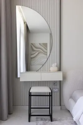 a mirror in a bedroom with a stool under it at Designer 3BR Lagoon Views Gym District One in Dubai