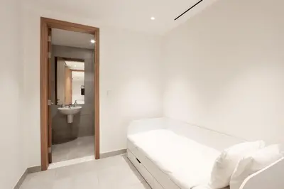 a white room with a bed and a sink at Beachfront 2BR with Maids Room One JBR Sea Palm Ain Atlantis Views in Dubai