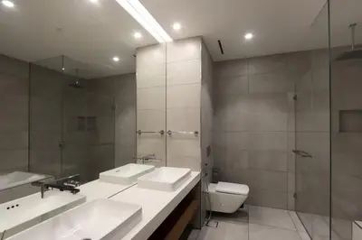 a bathroom with two sinks and a toilet at Beachfront 2BR with Maids Room One JBR Sea Palm Ain Atlantis Views in Dubai