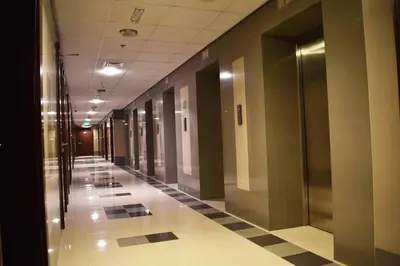 an empty hallway in a building with ailed floor at Luxury Studio Apartment in the beautiful Dubai in Dubai