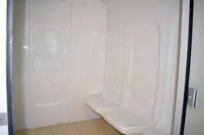 a white shower stall with a toilet in a bathroom at Luxury Studio Apartment in the beautiful Dubai in Dubai