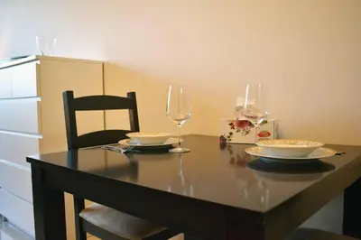 a table with two plates and a glass of wine at Luxury Studio Apartment in the beautiful Dubai in Dubai