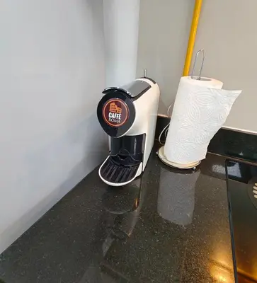 a coffee maker and a roll of paper on a counter at Luxury Studio Apartment in the beautiful Dubai in Dubai