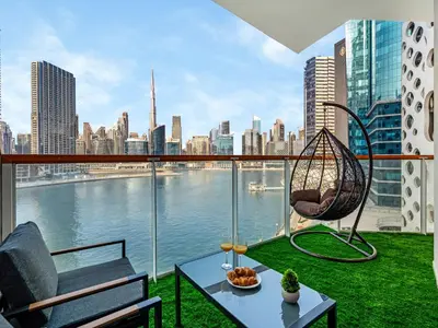 a balcony with a hammock and a view of the city at Stunning Burj Khalifa & Lake View 2BR with GYM and Pool in Dubai