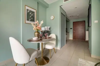 a dining room with blue walls and a table and chairs at Modern Downtown Studio with Balcony & Parking in Dubai