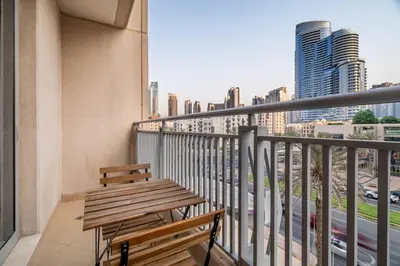 a balcony with a bench and a view of a city at Modern Downtown Studio with Balcony & Parking in Dubai
