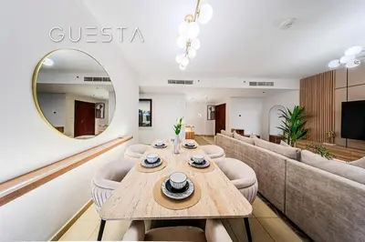 a living room with a table and a couch at Jumeirah Beach Residence - Murjan 5, Dubai Marina in Dubai