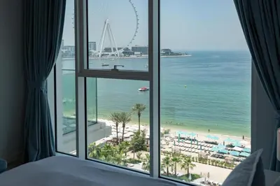 a room with a view of a beach and the ocean at Luxury 2BR with Panoramic Sea View Private Beach in Dubai