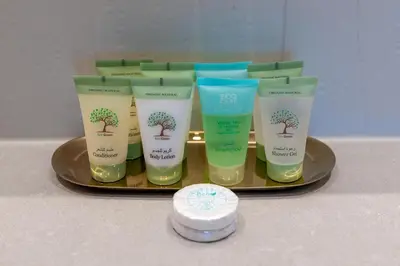 a group of four bottles of sunscreen on a tray at Luxury 2BR with Panoramic Sea View Private Beach in Dubai