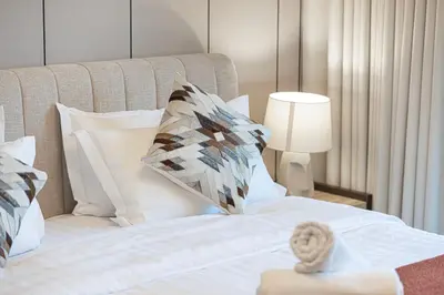 a hotel room with a bed with a pillow on it at Luxury 1BHK Burj Khalifa & Canal View in Dubai