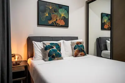 a bedroom with a bed with two pillows and a mirror at Burj Khalifa View-Beautiful Pool-Gym-Business Bay in Dubai