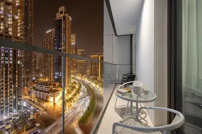 a balcony with a table and a view of a city at BURJ CROWN - Elegant & Spacious Two-Bedroom Apartment in Downtown Dubai, Just 10 Minutes' Walk from Dubai Mall & Dubai Fountains, Surrounded by Iconic Landmarks in Dubai
