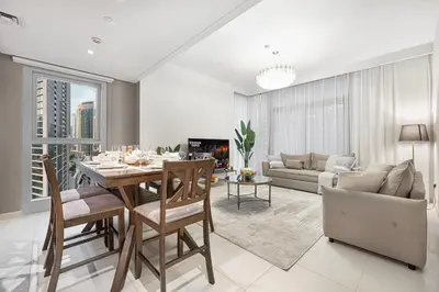 a living room with a dining table and a couch at BURJ CROWN - Elegant & Spacious Two-Bedroom Apartment in Downtown Dubai, Just 10 Minutes' Walk from Dubai Mall & Dubai Fountains, Surrounded by Iconic Landmarks in Dubai