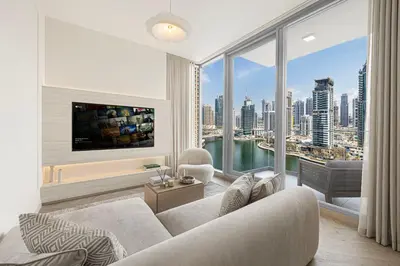 a living room with a couch and a large window at Daniels 2BR with Maid Room at Liv Residency with Marina View in Dubai