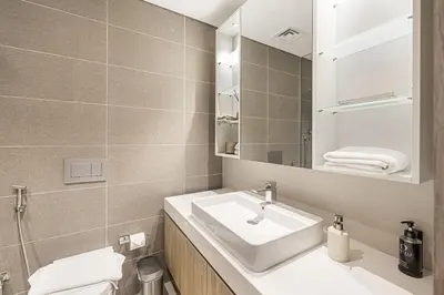 a bathroom with a sink and a mirror at Daniels 2BR with Maid Room at Liv Residency with Marina View in Dubai