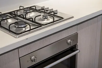 a stove top oven sitting in a kitchen at Daniels 2BR with Maid Room at Liv Residency with Marina View in Dubai