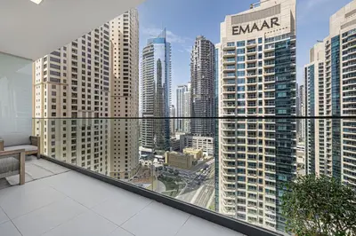 an apartment balcony with a view of a city at Daniels 2BR with Maid Room at Liv Residency with Marina View in Dubai