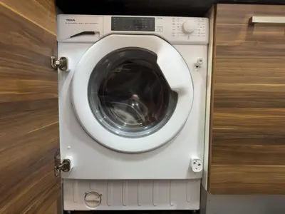 a washing machine with its door open next to a cabinet at Studio Apartment in Sparkle Tower Dubai Marina in Dubai