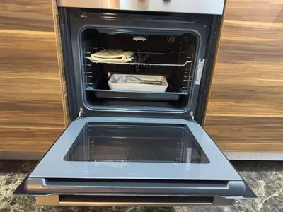 an oven with its door open in a kitchen at Studio Apartment in Sparkle Tower Dubai Marina in Dubai