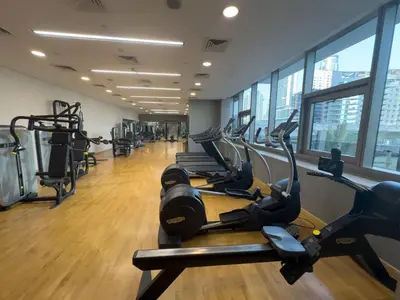 a gym with treadmills and elliptical machines at Studio Apartment in Sparkle Tower Dubai Marina in Dubai