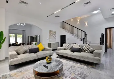 a living room with two couches and a table at 5BR & Maids Room with Private Pool in The Aldea, The Villa - Allsopp & Allsopp in Dubai