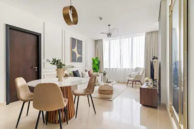 a white living room with a table and chairs at Silkhaus Comfy 1BDR at Sky Gardens in DIFC-NEW in Dubai
