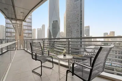 a balcony with two chairs and a table on a building at Silkhaus Luxury Studio at Sky Gardens in DIFC Views in Dubai