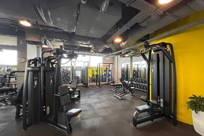 a gym with lots of treadmills and chairs in it at Silkhaus Luxury Studio at Sky Gardens in DIFC Views in Dubai