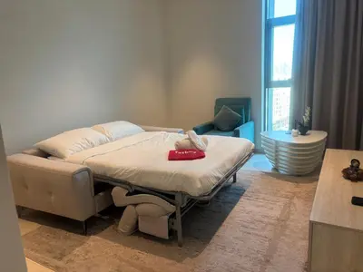 a bedroom with a bed with a red tray on it at Spacious 1 bed with seaview in Seven Palm - Palm Jumeirah - IQPRO Holidays in Dubai