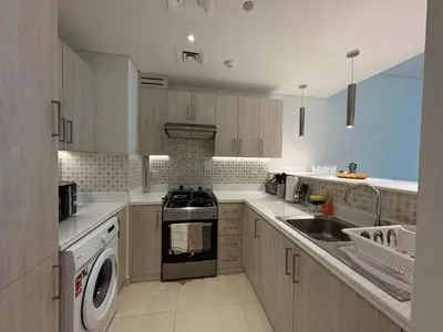 a kitchen with a stove and a dishwasher at Spacious 1 bed with seaview in Seven Palm - Palm Jumeirah - IQPRO Holidays in Dubai